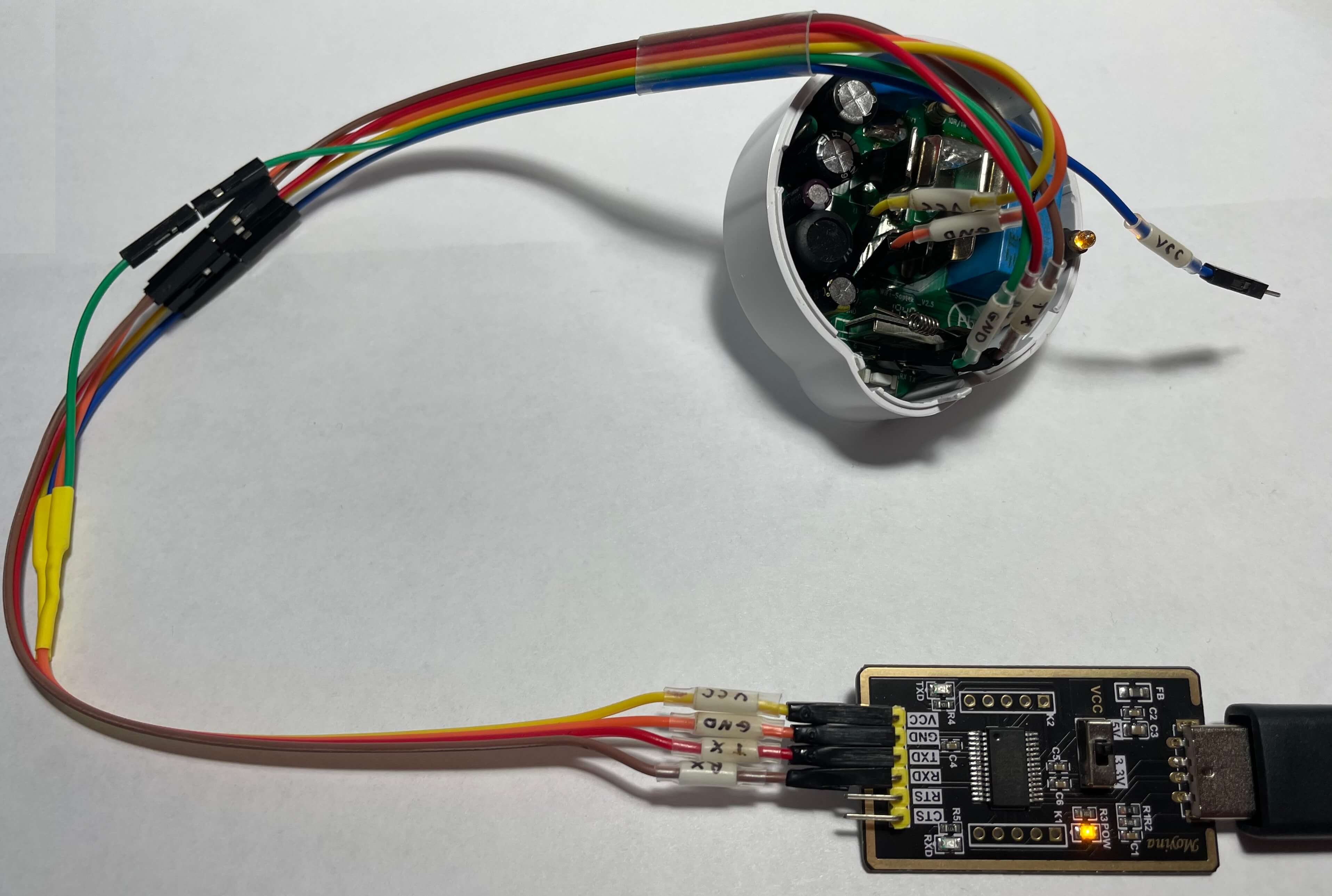 An angled view of the Etekcity Voltson ESW01-USA-R6P connected to a USB serial converter as described in the table above and booted into Flash Mode.